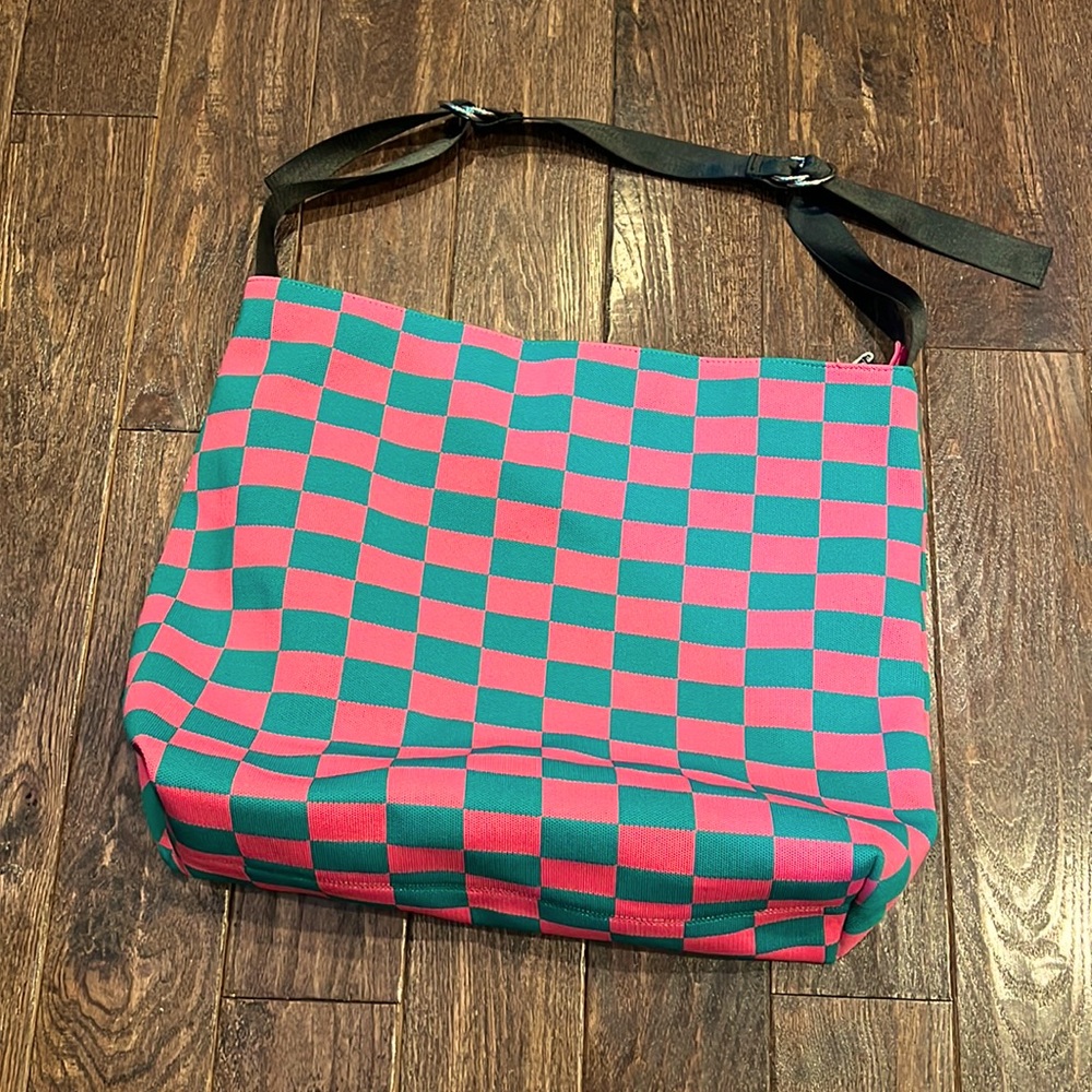 Large tote. Bought it in Poland for a last minute flight. Adjustable straps.